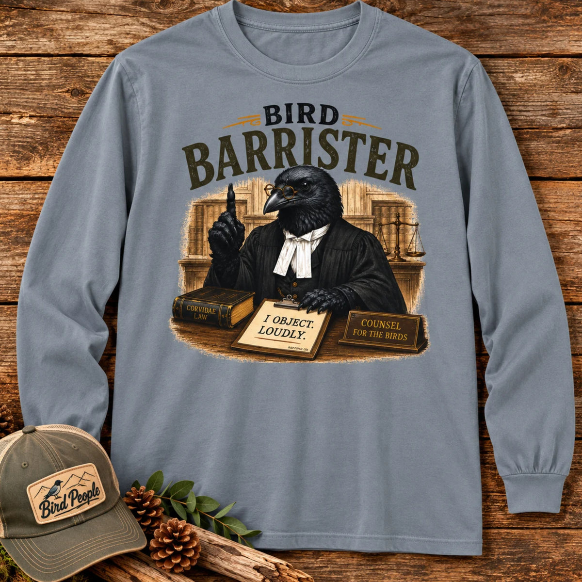 Bird Barrister crow long sleeve t-shirt in Granite, flat lay on a rustic wood plank background — funny lawyer crow design for birdwatchers and bird lovers.